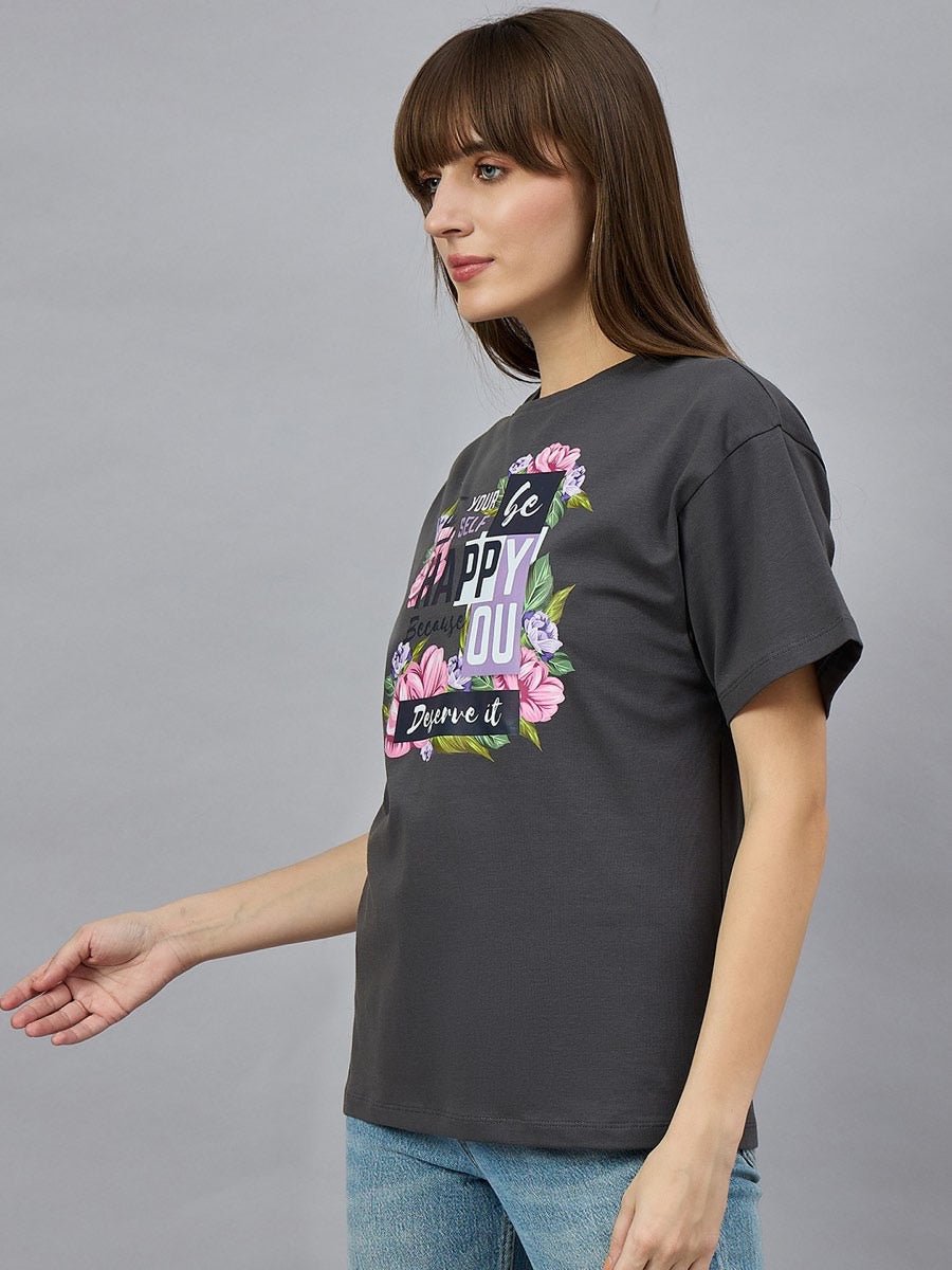 Woman wears 98degreenorth Typography Graphic Cotton Tee with drop shoulder sleeves, paired with blue jeans.