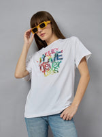 Woman in sunglasses wears a 98degreenorth Relax Fit Cotton Typography Graphic T-shirt and light blue jeans.
