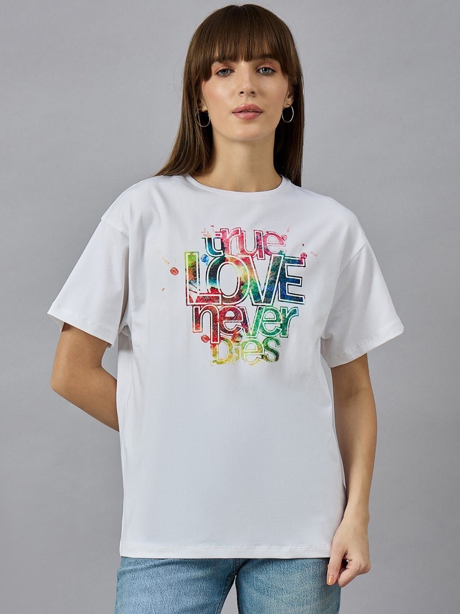 Woman wears 98degreenorth Relax Fit Cotton Typography Graphic T-shirt with true LOVE never dies print, against gray background.