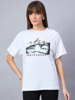 Woman wears 98degreenorth Typography Print Drop Shoulder T-shirt, Stay Independent, against a gray background.
