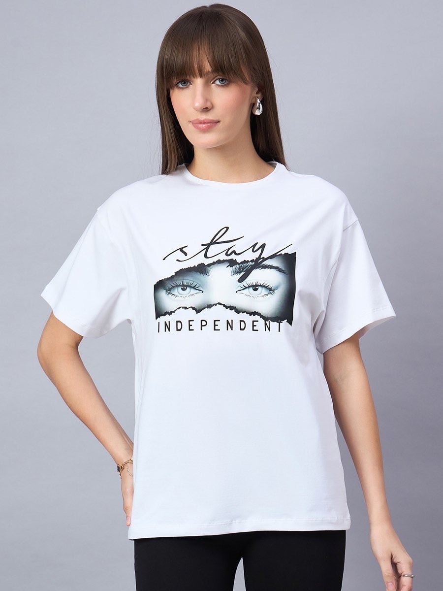 Woman wears 98degreenorth Typography Print Drop Shoulder T-shirt, Stay Independent, against a gray background.