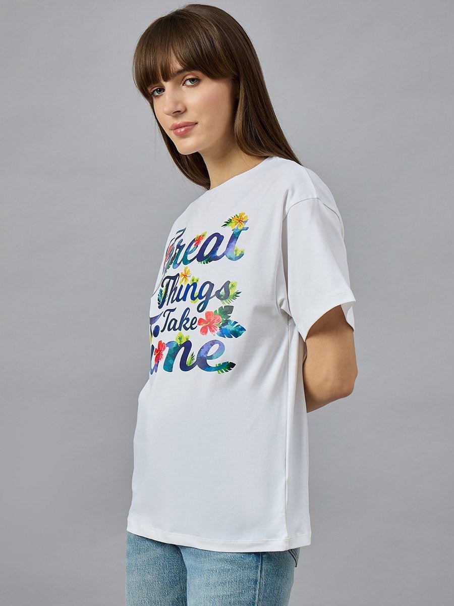 Woman in a white 98degreenorth Urban Streetwear Typography T-shirt, 100% cotton, round neck, against a gray background.