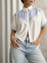 Woman wears 98degreenorth's White Blue Colour Block Cotton Shirt and light-wash jeans, hand in pocket.