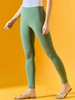 Model wears 98degreenorth Women Bright Green Ankle-Length Leggings with a white top and beige sandals, yellow background.
