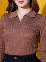 Woman in a 98degreenorth camel ribbed collar sweater, handcrafted for effortless style, against a yellow background.