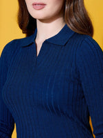 Woman in 98degreenorth Women Cobalt Blue Ribbed Knit Collar Sweater, standing against a yellow background.