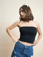 Woman wears 98degreenorth Women Cotton Black Crop Tube Top with ripped jeans and sunglasses against a beige background.