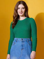 Woman wears 98degreenorth Women Emerald Green Ribbed Sweater and denim skirt, standing against a yellow background.