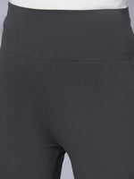 Close-up of a person wearing 98degreenorth Women High-Rise Charcoal Cotton Trousers with a white top, highlighting the stretchable high-rise waistband and upper thighs.