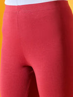 Close-up of 98degreenorth Women Maroon Ankle-Length Leggings with white waistband on a vivid yellow background.