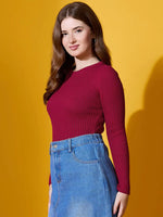 A woman wears the 98degreenorth maroon ribbed sweater, a chic slim-fit pullover, against a yellow background.