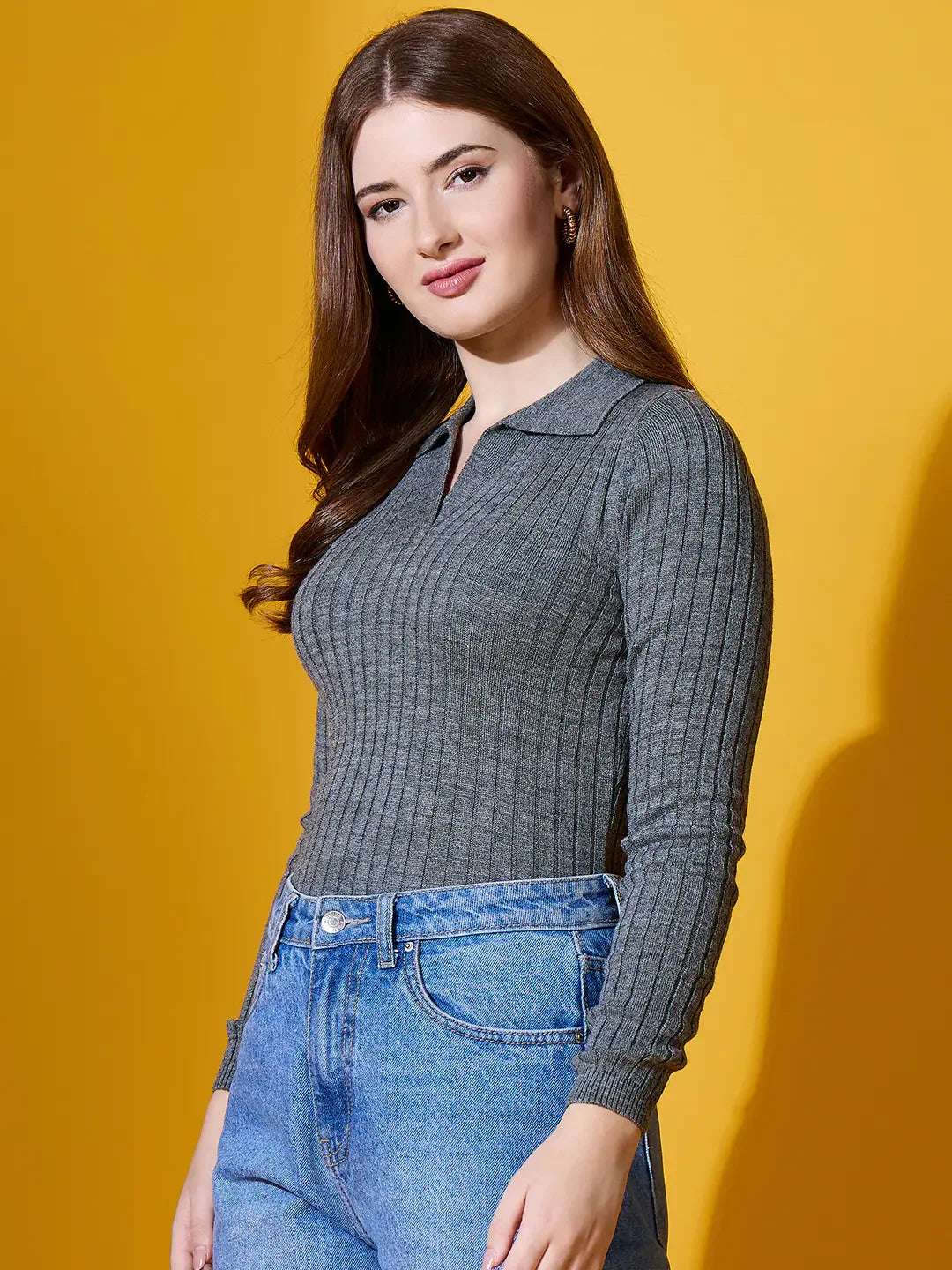 Woman in a 98degreenorth Medium Grey Ribbed Collar Sweater, cozy lightweight knit, against a yellow background.