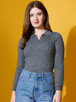 Woman with long brown hair wears 98degreenorth’s grey ribbed collar sweater with blue jeans against a yellow background.