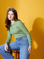 Woman in 98degreenorth Pear Collar Neck Sweater and jeans sits on stool, wearing cat-eye sunglasses.