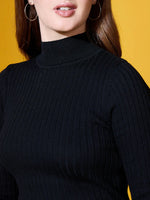 Woman wearing 98degreenorth’s black ribbed high neck sweater, styled with hoop earrings on a vibrant yellow background.