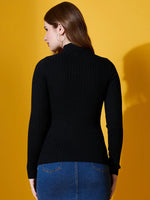 Woman in 98degreenorth Ribbed High Neck Sweater (Black) and denim skirt, facing away against yellow backdrop.