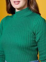 Woman in a 98degreenorth emerald green ribbed high neck sweater, shoulders up, on a vibrant yellow background.