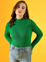 Woman in a 98degreenorth green ribbed high neck sweater and jeans stands against a bright yellow background.