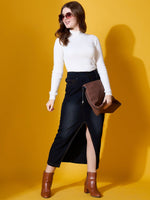 Woman wears 98degreenorth Ribbed High Neck Sweater—white, styled with a denim skirt and boots against a yellow background.