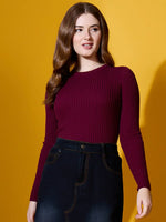 Woman in a 98degreenorth rosewood ribbed sweater and dark high-waist jeans, styled chic for winter against yellow.