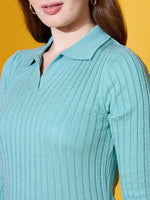 A woman wears a Women Sea Green Ribbed Collar Neck Sweater by 98degreenorth against a yellow background.
