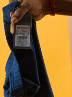 A hand holds 98degreenorth Women Teal Blue Ankle-Length Leggings against a bright yellow background.