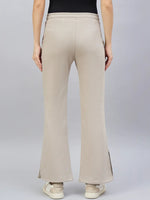 A person wears 98degreenorth Women’s Almond Flared Bootcut Sweatpants with white sandals, shown from the back.