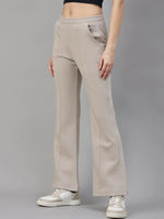 A person wears 98degreenorth Women’s Almond Fleece Flared Sweatpants, white sneakers, and a black crop top.