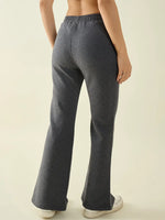 Person wears 98degreenorth Women’s Anthra Flared Bootcut Sweatpants with Side Slit, shown from the back.