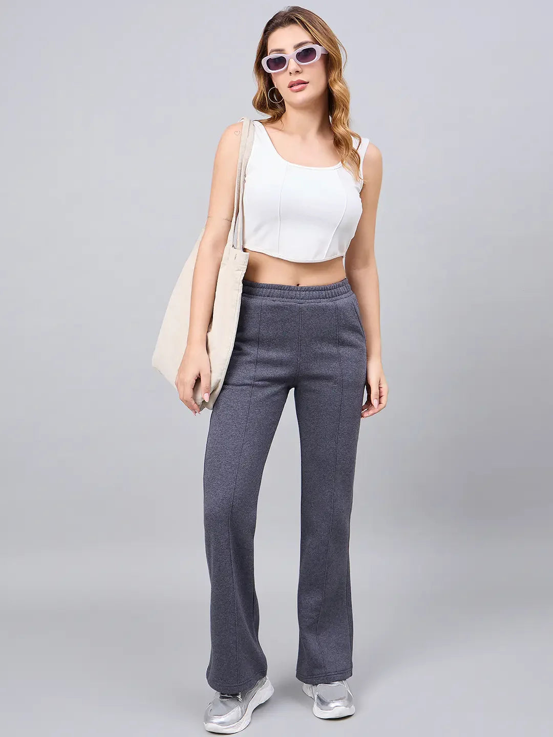 Woman wearing 98degreenorth Women’s Anthra Fleece Flared Sweatpants for a chic, casual street style look.