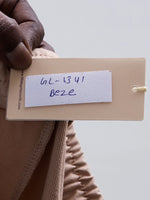 A hand holds a beige tag labeled GL-1341 BEZE for 98degreenorth Women’s Beige Cotton Stretchable Trackpants.