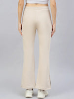 Model in 98degreenorth Women’s Beige Flared Bootcut Sweatpants, shown from the back against a plain gray background.