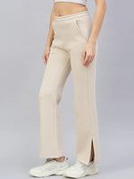 98degreenorth Women’s Beige Flared Bootcut Sweatpants—soft cotton fleece, high-waist, side slit—styled with sneakers.