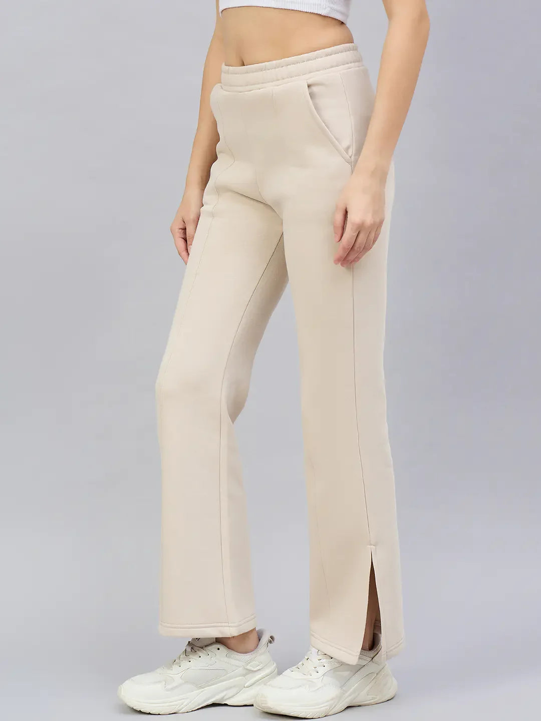98degreenorth Women’s Beige Flared Bootcut Sweatpants—soft cotton fleece, high-waist, side slit—styled with sneakers.