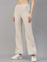 Model wears 98degreenorth Women’s Beige Fleece Flared Lounge Pants, posing against a plain grey background.