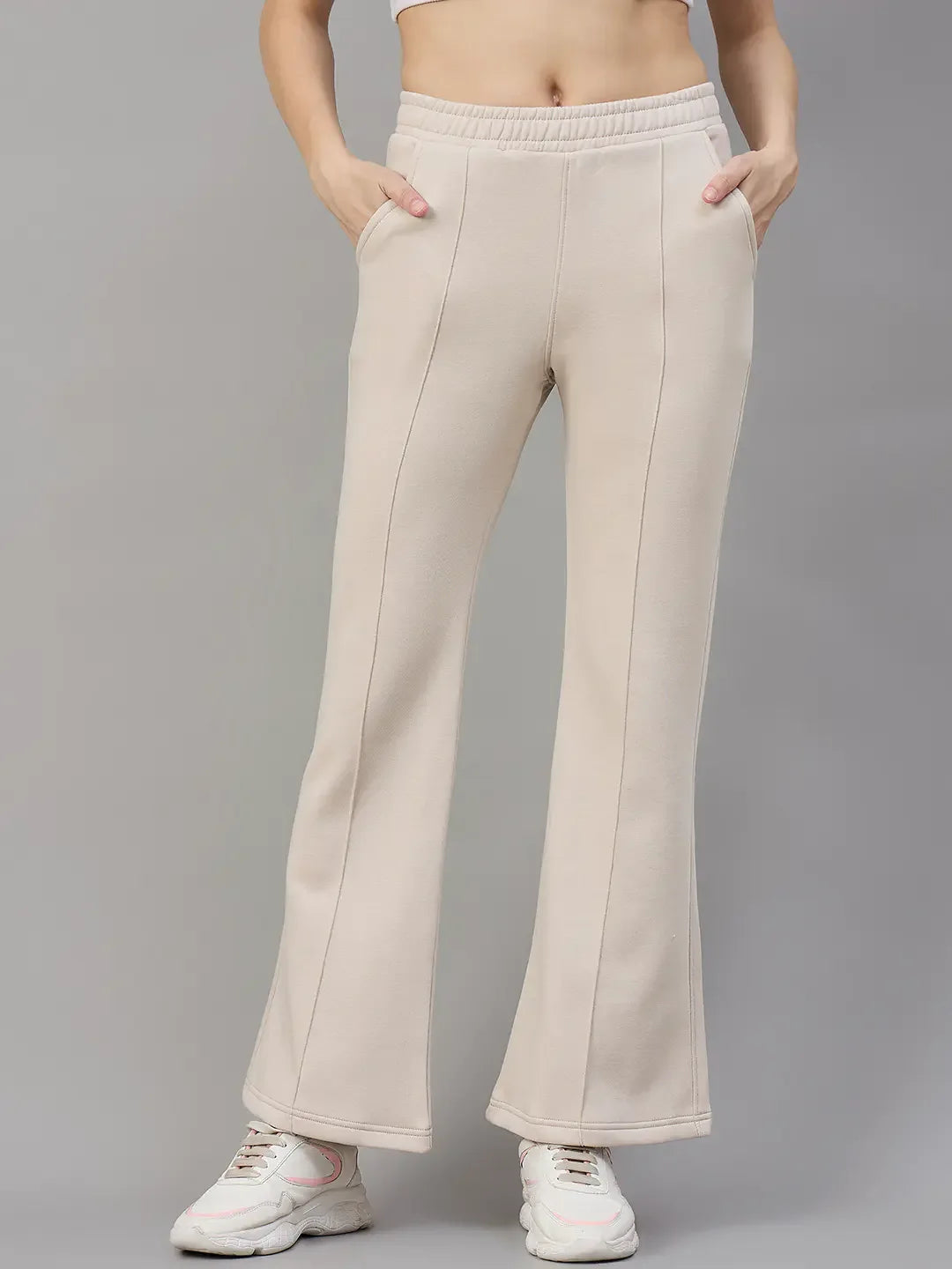 98degreenorth Women’s Beige Fleece Flared Lounge Pants offer warm, stylish winter loungewear against a gray backdrop.
