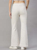 Model wears 98degreenorth Women’s Beige Fleece Flared Sweatpants, minimal streetwear style, shown from the back.