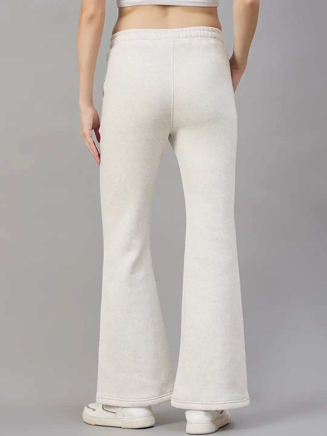 Model wears 98degreenorth Women’s Beige Fleece Flared Sweatpants, minimal streetwear style, shown from the back.