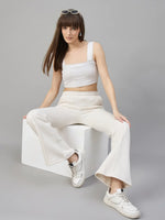 Woman wears 98degreenorth Beige Fleece Flared Sweatpants, showing off minimal streetwear style with fresh white sneakers.