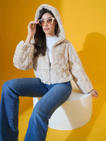 Woman in 98degreenorth Women’s Beige Luxe Faux Fur Hooded Jacket poses against a bright yellow background.