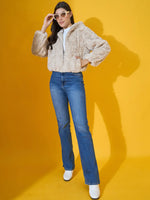 Woman in 98degreenorth Beige Luxe Faux Fur Hooded Jacket poses against a yellow background.