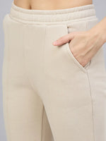 Close-up of 98degreenorth Women’s Beige Multi Bootcut Sweatpants with flared side-slit and elastic waistband.