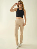 Woman in sunglasses wears 98degreenorth Women’s Beige Straight Fit Cotton Stretchable Trousers against a plain background.