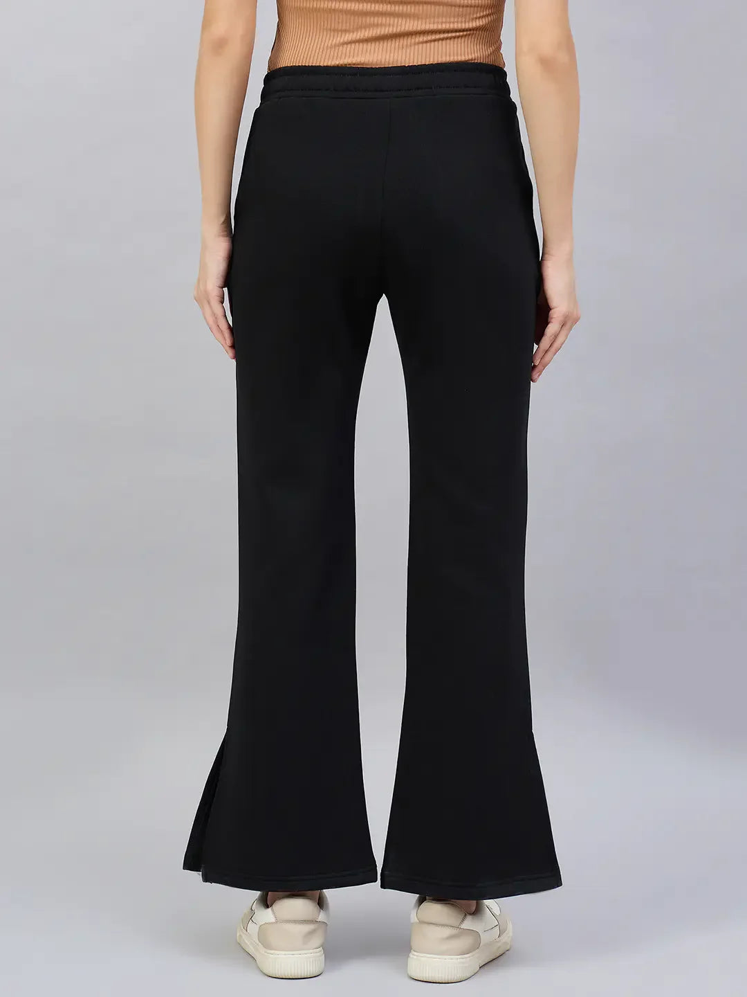 Model wears 98degreenorth Women’s Black Bootcut Sweatpants with Side Slit, shown from the back on a plain grey background.