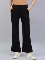 Model wears 98degreenorth Women’s Black Bootcut Sweatpants with Side Slit, paired with a beige top and white sneakers.