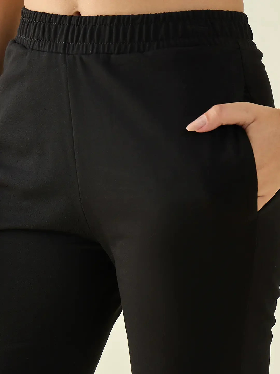 Close-up of a person wearing 98degreenorth Women’s Black Flared Fit Bootcut Cotton Stretchable Trousers.