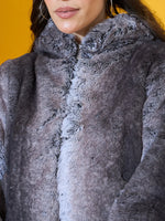 Model in a 98degreenorth Women’s Black Premium Faux Fur Jacket with hood, an urban winter essential.