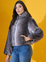 Woman in a 98degreenorth Women’s Black Premium Faux Fur Jacket with plush hood poses against a yellow background.