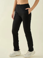 Model wears 98degreenorth Women’s Black Regular Fit Cotton Stretchable Trousers, paired with white sneakers.