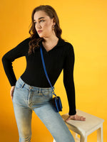 Woman in a 98degreenorth Women’s Black Ribbed Collar Neck Sweater and jeans poses with a blue purse against yellow.